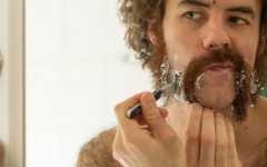 A guy shaving for movember.