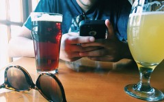 A man who's on a date with his girlfriend texting his ex.