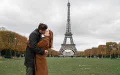 A couple in a healthy relationship kissing in front of the Eiffel Tower.