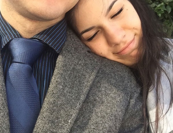 A girl resting her head on her guy friend's shoulder because he is so in the friend zone.