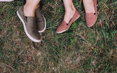A couple's feet as they lay down on a picnic blanket on a first date.