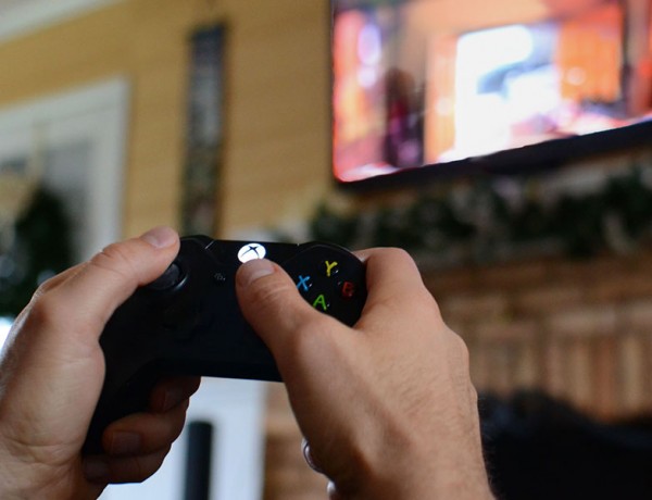 A man in a healthy relationship laying video games alone to get some time for himself.