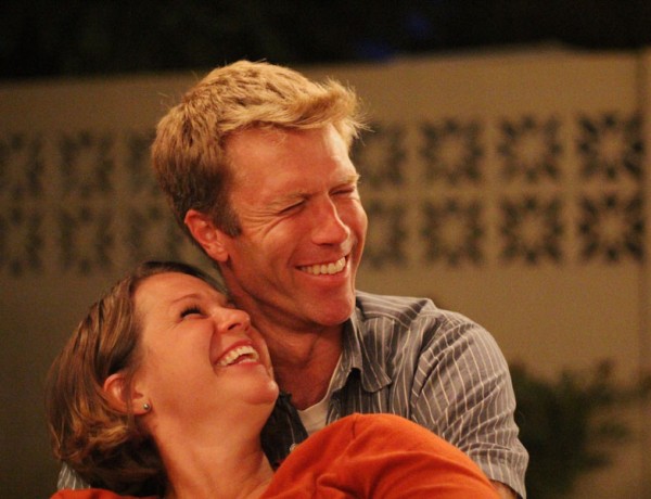 A couple in a healthy relationship smiling and laughing together.