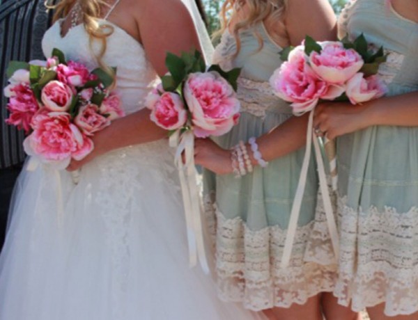 Bridesmaids lined up next to a bride at a wedding.