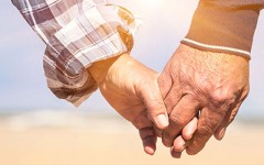 An older couple holding hands because age doesn't matter in their relationship.