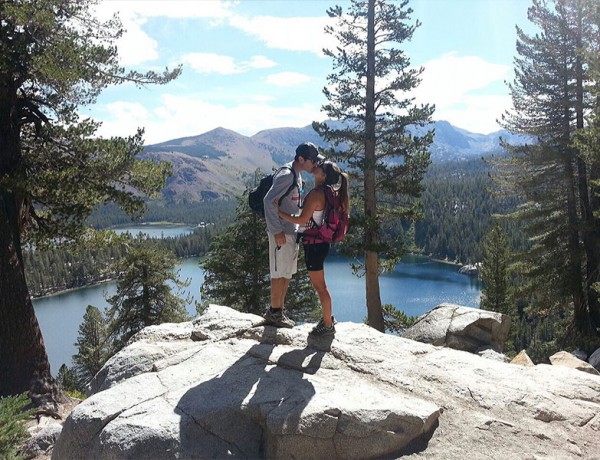 A couple kissing on a hike because it was a cheap first date idea for them.