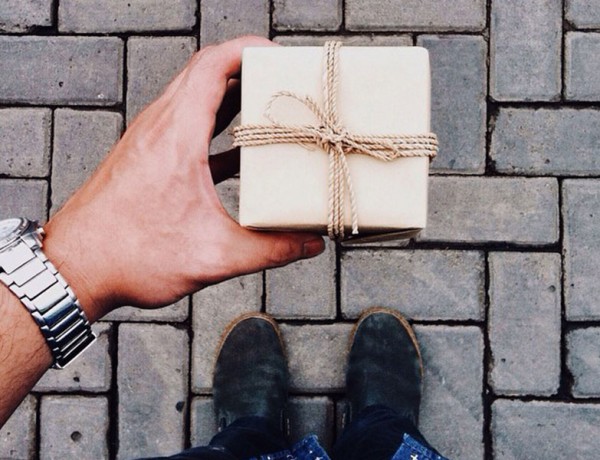 A man at a good state in his relationship giving a gift.