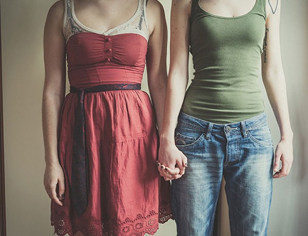 Two women holding hands.
