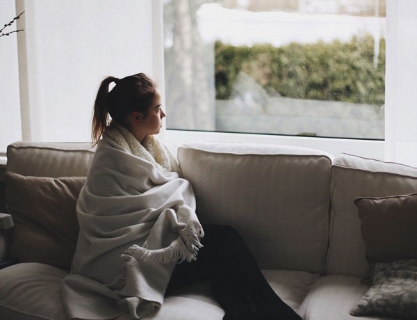 A woman in a long distance relationship looking out the window.