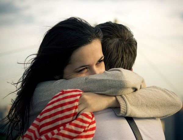 A woman hugging a man.