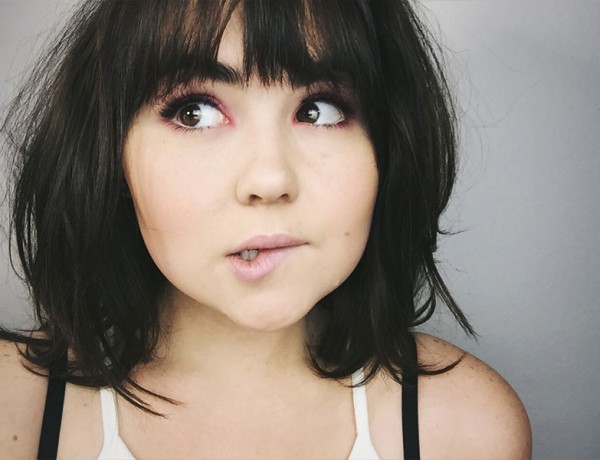 A woman who is making a nervous face because she's about to go on a first date.