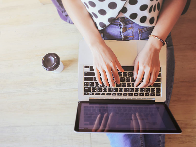 A woman writing an online dating profile.