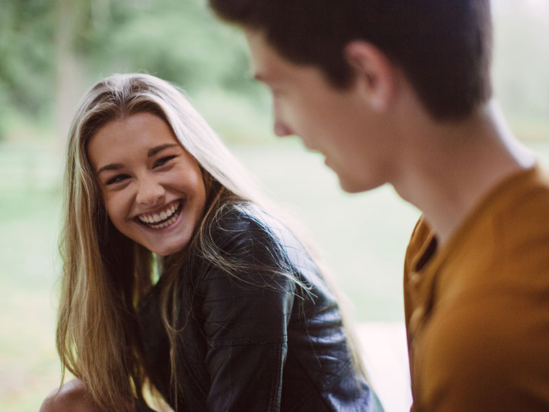 A girl flirting with a guy who is nervous and shy.