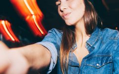 A girl talking a selfie of herself for her online dating profile.