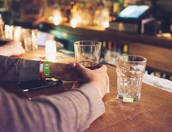 A man at a bar about to have a drink.