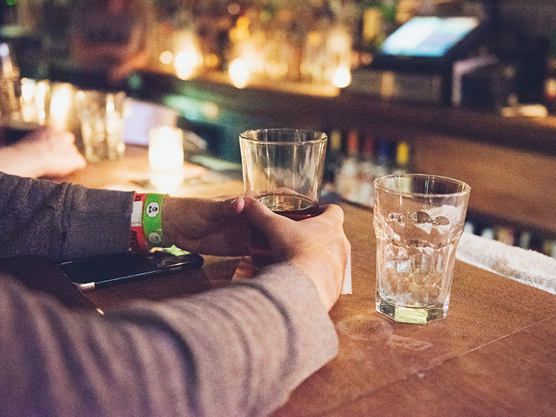 A man at a bar about to have a drink.