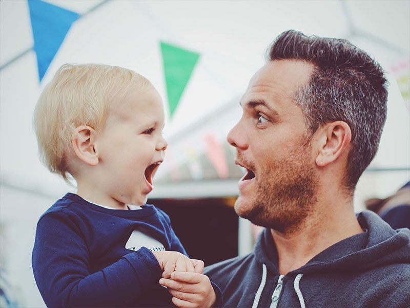 A single dad making a face at his son.