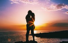 Two people having a summer love on a beach.