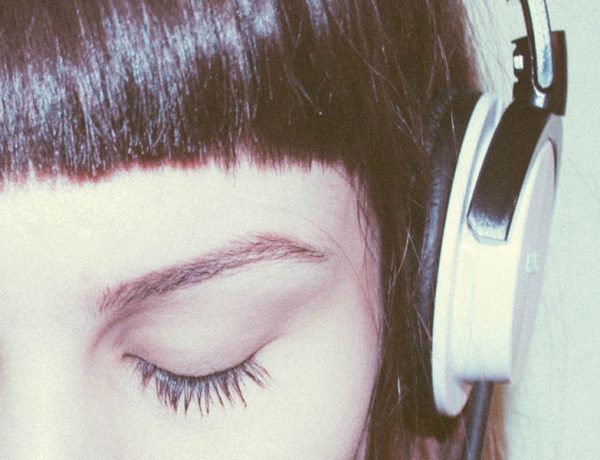 A woman listening to moving on songs after a breakup.