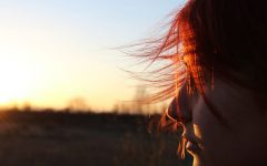 A girl who's moving on after a breakup thinking about things as she looks at the sunset.