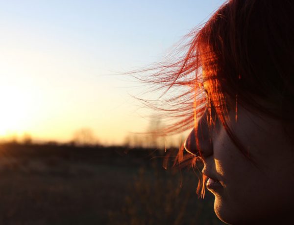 A girl who's moving on after a breakup thinking about things as she looks at the sunset.