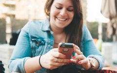 A girl text flirting with her phone.