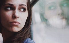 A woman looking out a window wondering how to know when to break up.