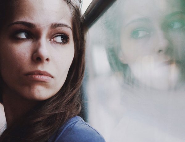 A woman looking out a window wondering how to know when to break up.