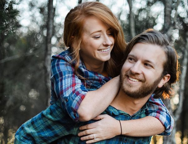A couple who were friends before having a relationship laughing together.