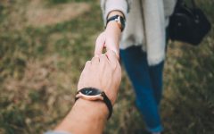 A couple dating in their 40s holding hands