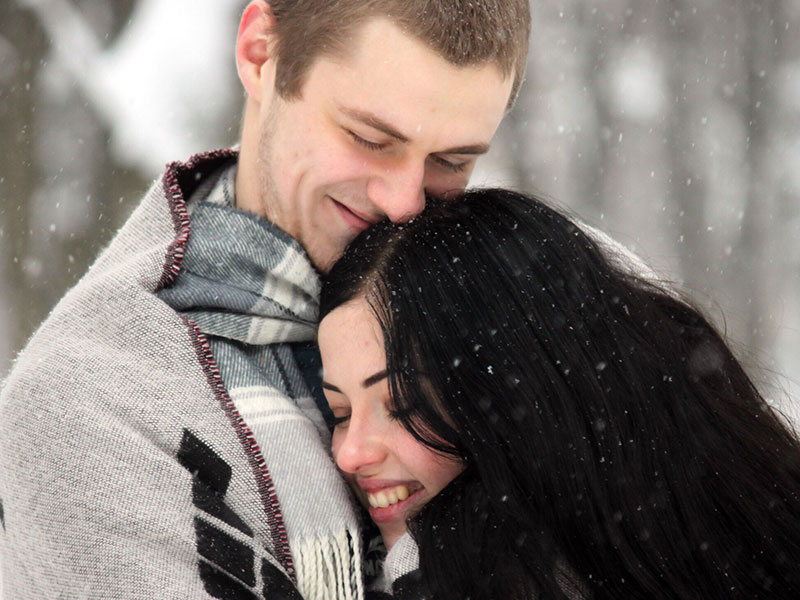 A woman who is what men want in a woman hugging her boyfriend.