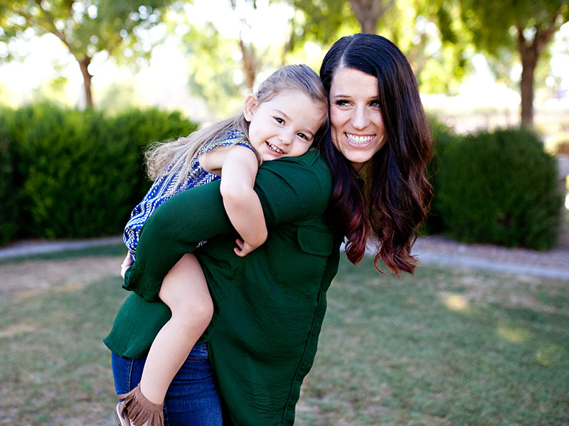 A single mom dating with kids laughs with her daughter.