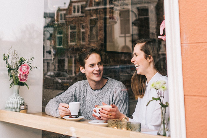 This couple is on a coffee date, one of the best date ideas according to women of all age groups.