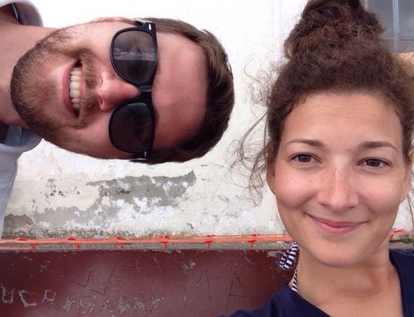 Two people who learned how to stay friends with an ex smiling together and being silly.