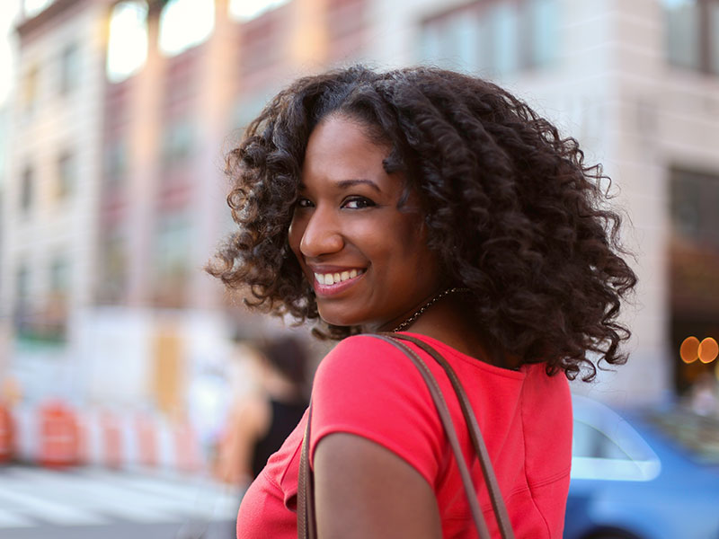 Women in their 50s like this one smiling over her shoulder date differently than younger women.