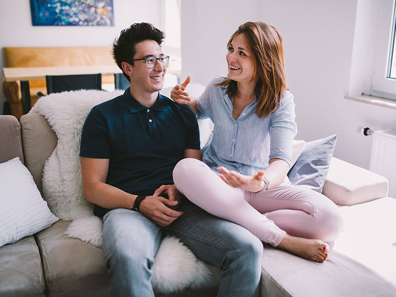 A couple laughing while having the exclusive relationship talk.