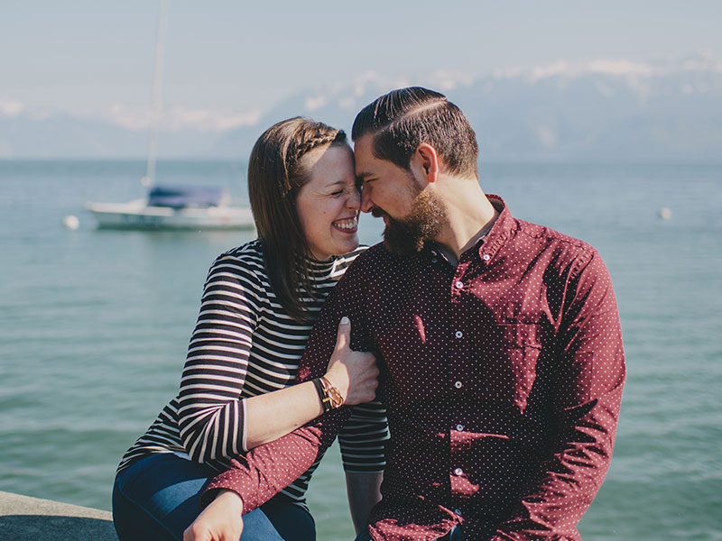 A girl laughing and cuddling with the man who learned how to ask a girl out.