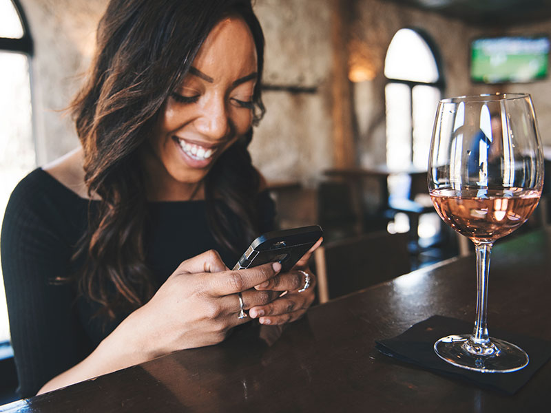 A woman answering a text from a man who wants to get a date with her.