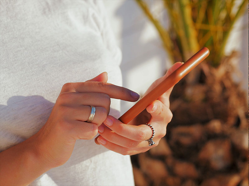 A woman on her phone setting up her online dating filters on her dating app.