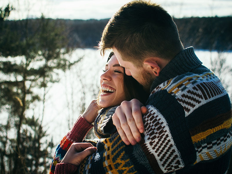 A couple hugging and laughing who learned these dating statistics.