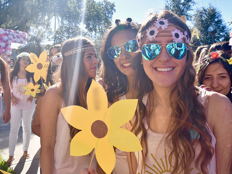 Get some dating tips from a former sorority girl like this one holding a yellow flower at bid day.