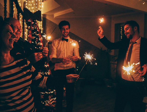 A woman who's single during the holidays having a great time at a holiday party.