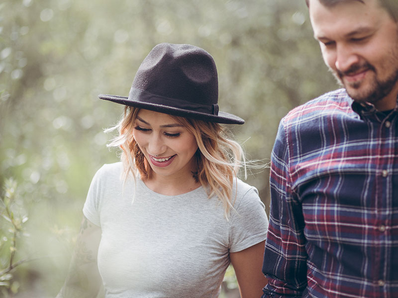 This couple walking in the woods together knows about younger women dating older men, because the man is five years older than his girlfriend.