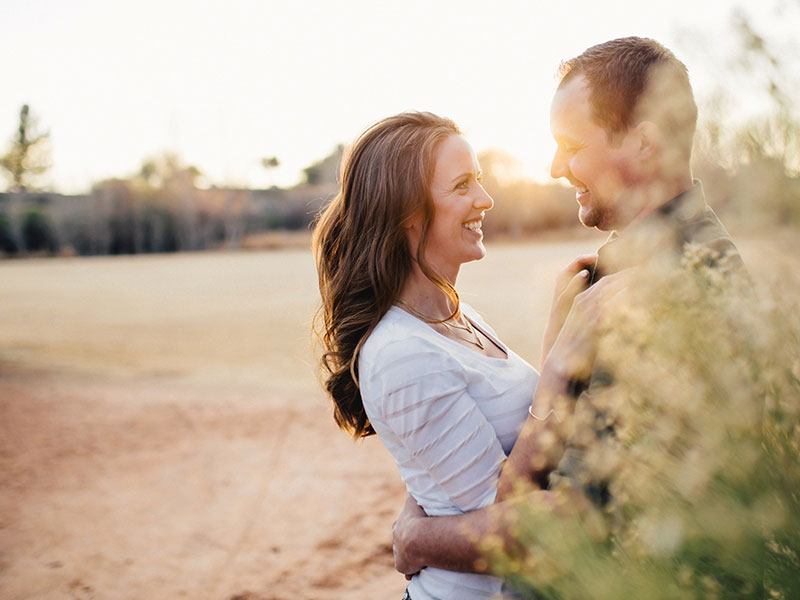 A happy couple hugging outside because they took these 5 tips for healthy relationships.