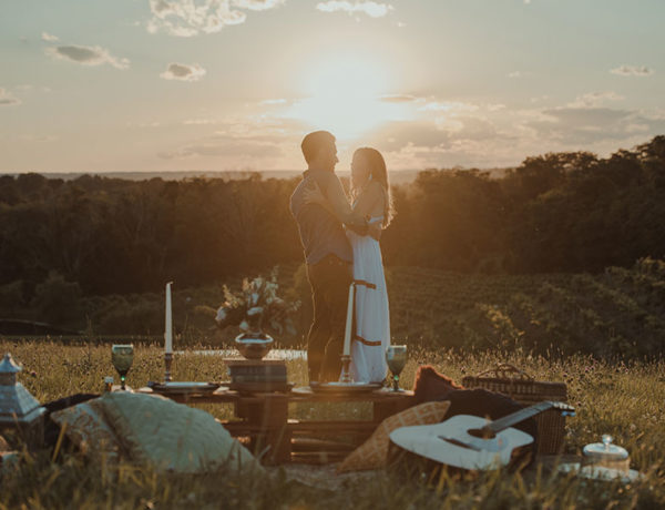 A man who used one of these ideas for romantic things to do standing on top of a hill at sunset with his happy girlfriend.