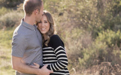 A woman who's single over 40 hugging her boyfriend who she didn't settle for in a sunny field.