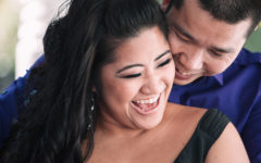 A couple that knows that love is sacrifice and compromise laughing with each other in the sun.