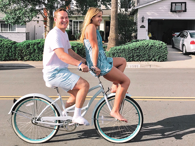 A woman riding a bike with her dating wondering about what the definition of exclusive dating vs a relationship is.