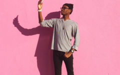 A guy standing against a pink background dating dating profile photos for his dating profile.