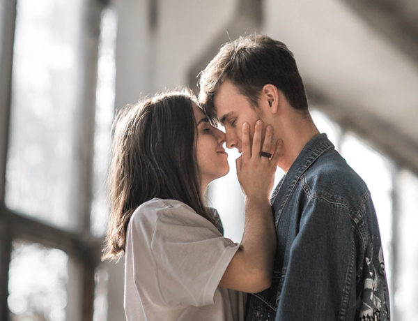 A girl kissing her date and wondering how many dates before it's a relationship.